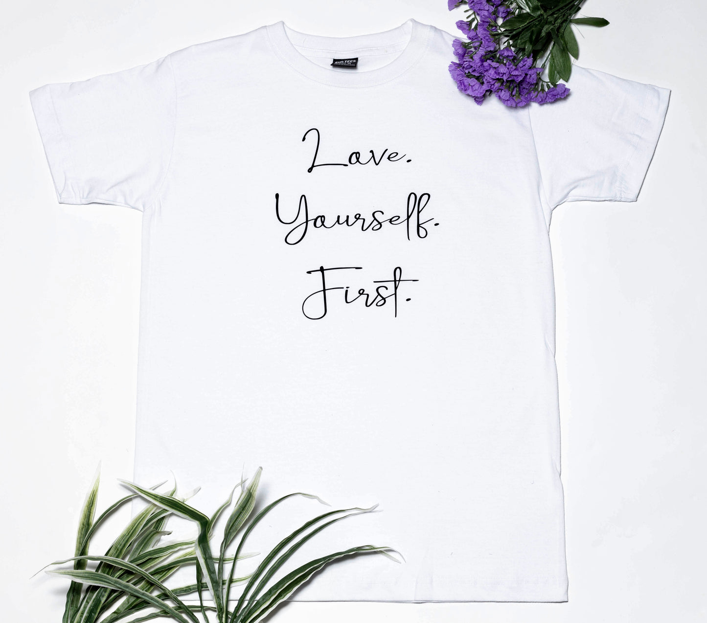 Short sleeve white t-shirt, with a very important message: Love. Yourself. First.