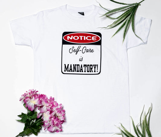 Short sleeve white t-shirt, with a very important notice: Self-Care is Mandatory!
